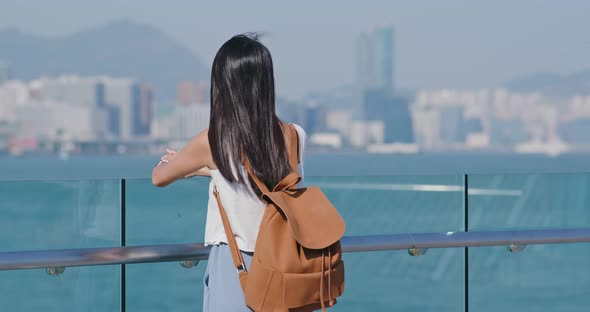 Woman enjoy the sea view in Hong Kong