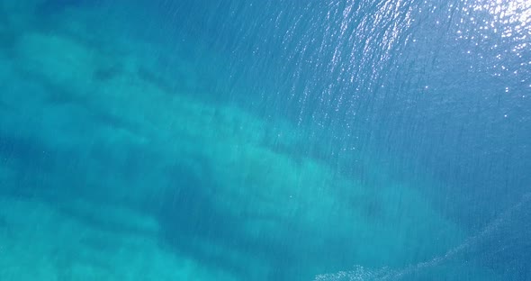 Beautiful overhead copy space shot of a white sandy paradise beach and blue sea background in hi res