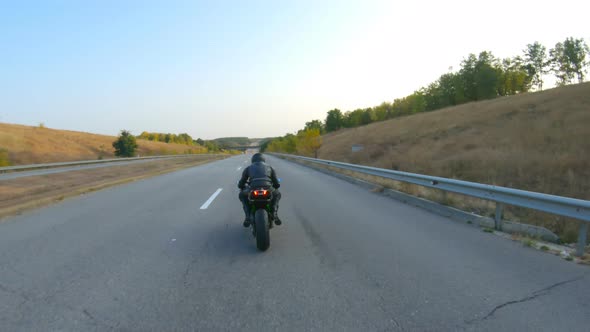 Follow to Motorcyclist Riding on Modern Sport Motorbike at Highway