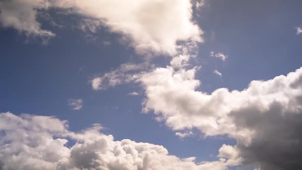 Time lapse clip of sunny blue sky with white gray cloudsing. Nice weather video, cloudscape