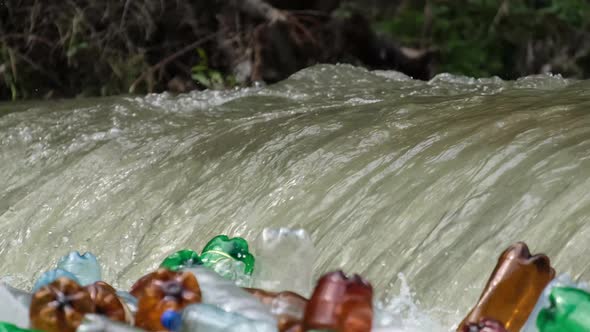 Lots of plastic trash in a mountain river. The problem of ecology.