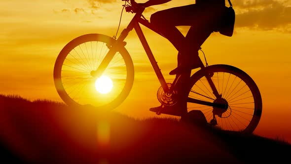 Cycling Mountain Climbing at Sunset alt