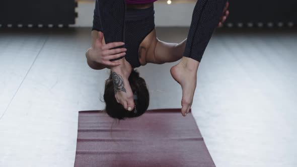 Young Woman Hanging on the Yoga Hammock