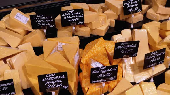 Various Chopped Pieces of Cheese with Price Tags on a Showcase in a Store