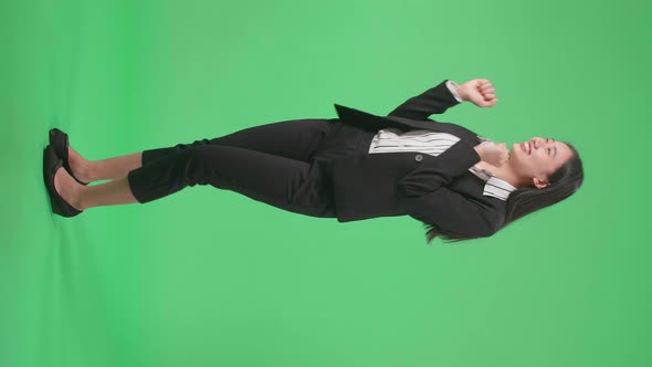 Full Side View Body Of A Smiling Asian Business Woman Dancing While On Green Screen Background