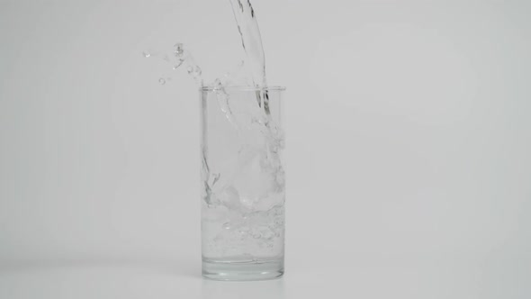 Slow Motion of Pouring Water in Transparent Glass with Ice 1000 Fps