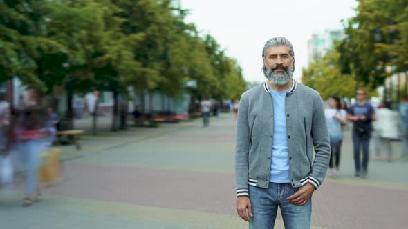 Time Lapse of Handsome Bearded Man Standing Outdoors in Crowded Pedestrian Street with People