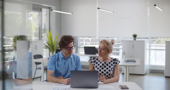 Work Colleagues Busy Brainstorm at Laptop in Office