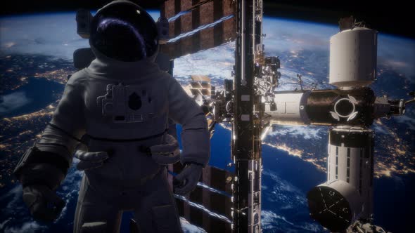 International Space Station and Astronaut in Outer Space Over the Planet Earth alt