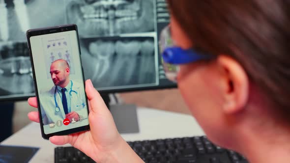 Close Up of Nurse Talking on Video Call with Specialist Dentistry Doctor