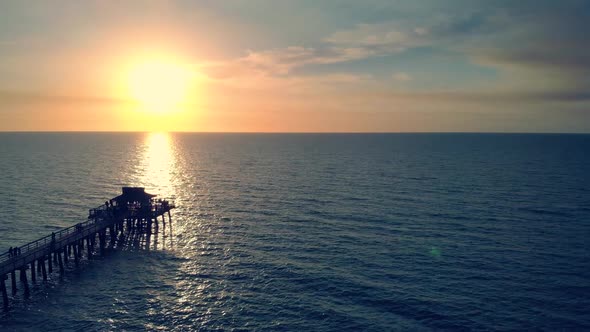 Silhouette of a Pier Over the Water at Sunset.