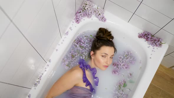 Sexy Beautiful Healthy Woman Lies in a Milk Bath