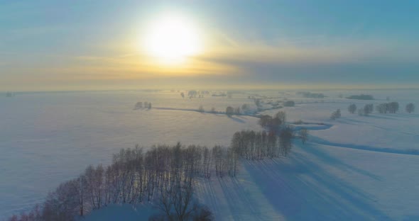 Aerial View of Cold Winter Landscape Arctic Field Trees Covered with Frost Snow Ice River and Sun