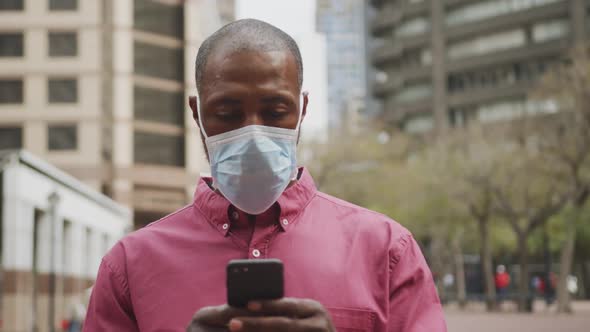 African american man on the go wearing coronavirus covid19 mask