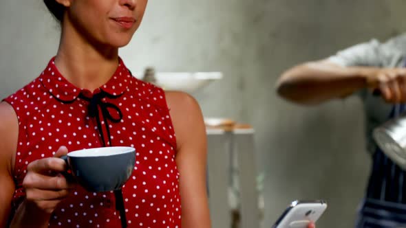 Woman talking on phone while having coffee 4K 4k