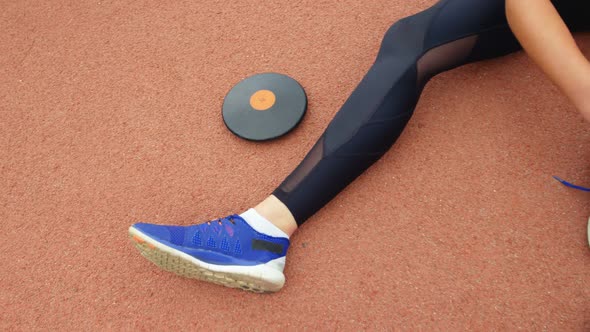 Low section of female athlete tying shoelaces at sport venue 4k