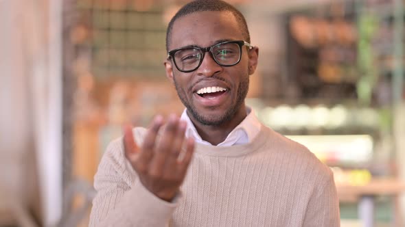 Portrait of Assertive African Man with Pointing and Inviting 