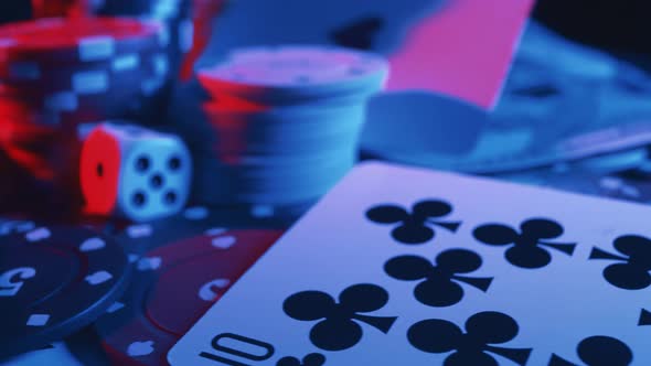 Casino Chips and Playing Cards with Money in Motion