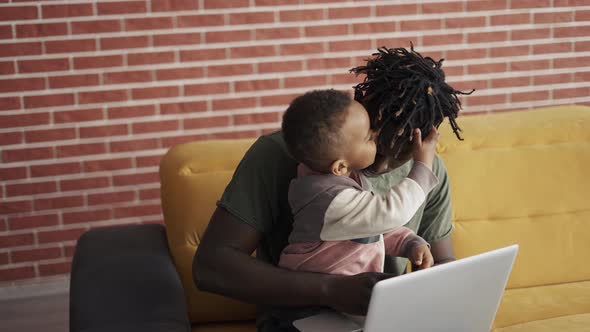 Black Father and Small Boy Learning Computer at Home for Child Education