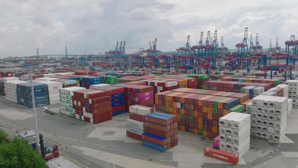 Aerial Ascending Footage of Varied Colour Standardised Containers Stacked in Large Harbour