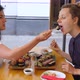 Brunette Girl Feeds Her Blonde Friend Sushi Roll. Sharing Food and Good Times with Friend - VideoHive Item for Sale