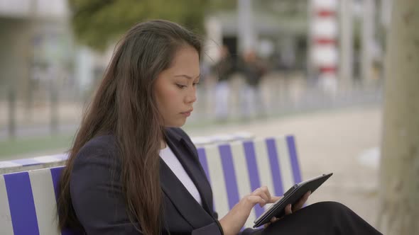 Focused Young Woman Using Digital Tablet