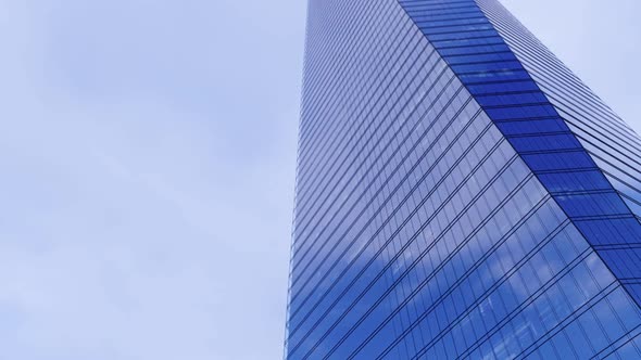 Blue Sky And White Clouds Reflecting In A Glass Building Time-Lapse alt