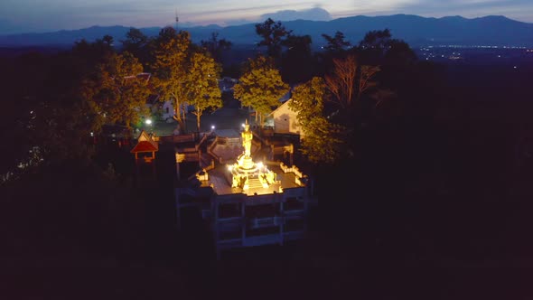 Aerial view of golden buddha pagoda stupa. Wat Phrathat Khao Noi Temple Park, Nan, Thailand