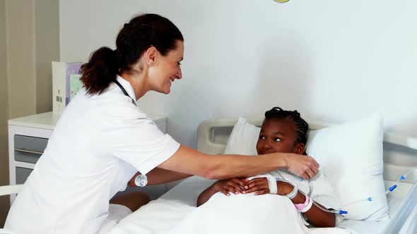 Female doctor consoling sick girl