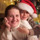 Portrait of Smiling Mother with Son in Santa Hat Lying on Floor on Christmas Eve - VideoHive Item for Sale