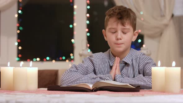 Boy Praying at the Table.