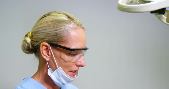 Female dentist assisting male patient to wear virtual reality headset