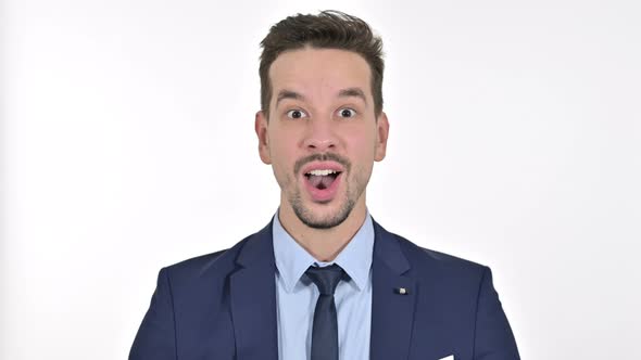 Portrait of Ambitious Young Businessman Celebrating Success, White Background