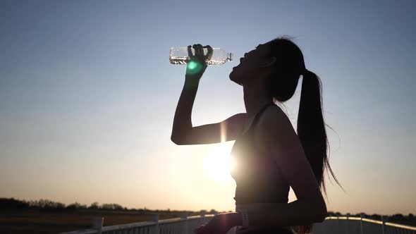 Women drinking water after exercise