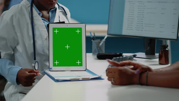 Close Up of Doctor Vertically Holding Tablet with Green Screen