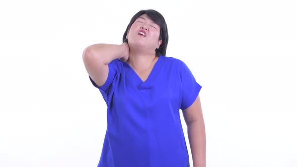 Stressed Overweight Asian Businesswoman Having Neck Pain