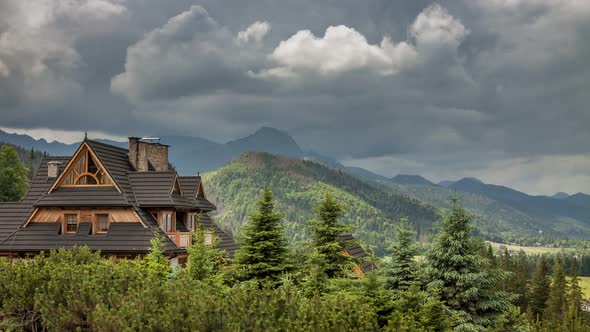 Stormy clouds over wooden cottage in Tatra Mountains, Zakopane, Poland, Timelapse