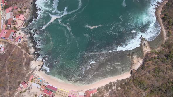 Drone flying over the island of Ixtapa located in the state of Guerrero, Mexico during a sunny day.