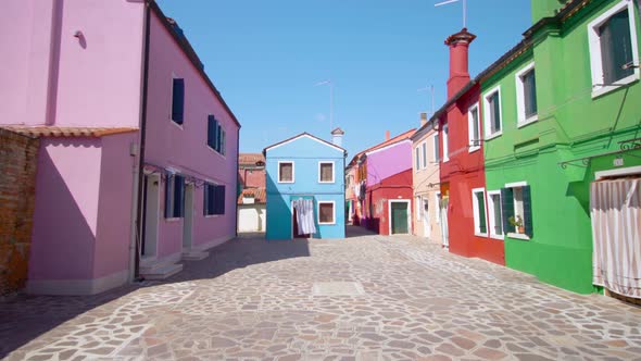 Sun Lighted Street with Colorful Houses Under Cloudless Sky