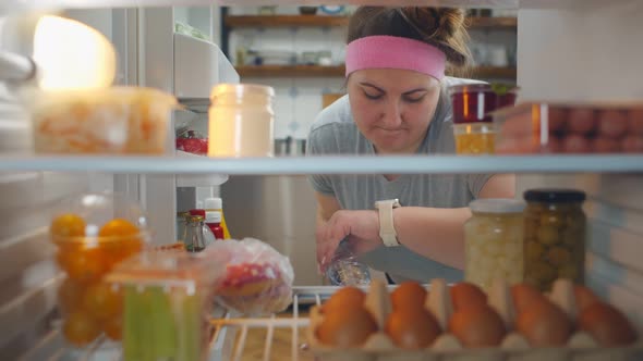 Fat Young Woman on Diet Take Yogurt From Refrigerator