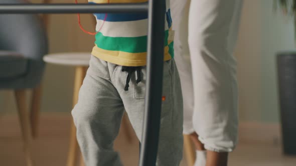 Asian Woman Exercising on Treadmill with Boy