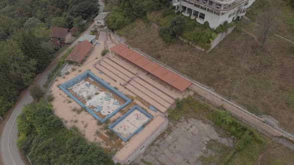 Abandoned Outdoor Pool And Demolished Hotel In The Mountains