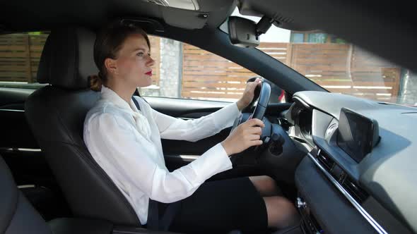 Woman Talking on In-car Speakerphone While Driving