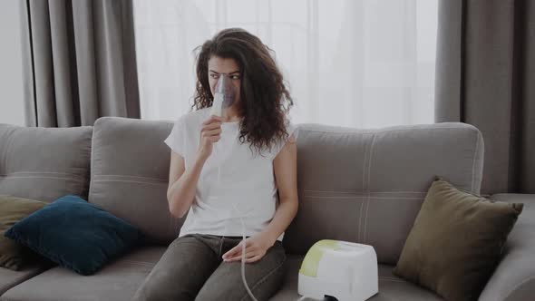 Young African American Woman Putting on Oxygen Mask Having an Asthma