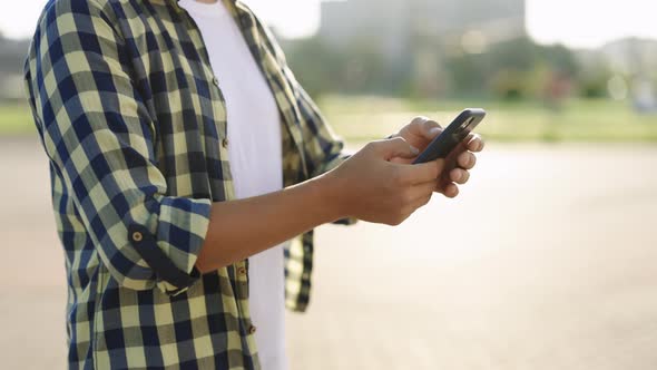 Close Up of Man Using Touch Mobile Phone Outdoor on City Street People and Cars Background