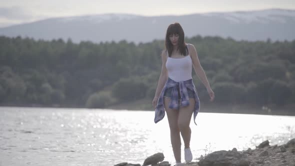 Cheerful woman walking near river