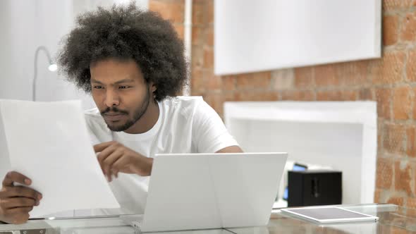 Paperwork By African Man in Office