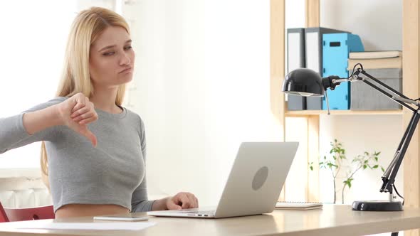 Thumbs Down,  Woman Gesturing while Sitting in Office