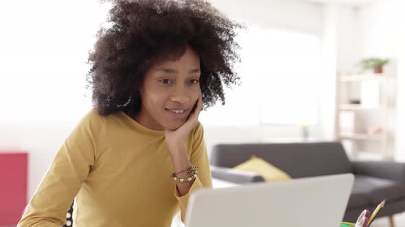 African Young Woman Using Laptop Computer at Home