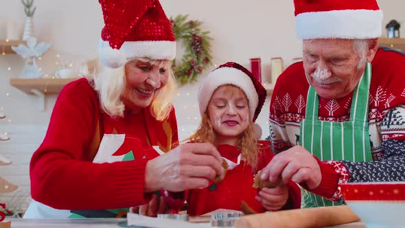 Senior Family Grandmother Grandfather Granddaughter Preparing Cooking Homemade Christmas Cookie